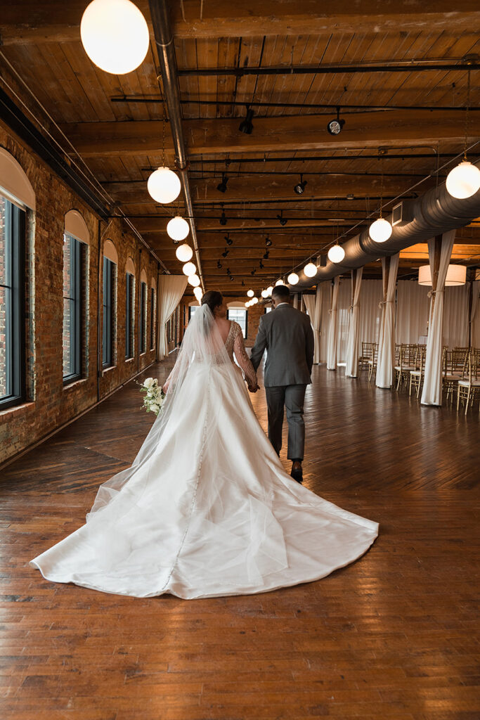 Congdon Yards Pine Room at the Loft bride and groom walking away from camera at historic venue