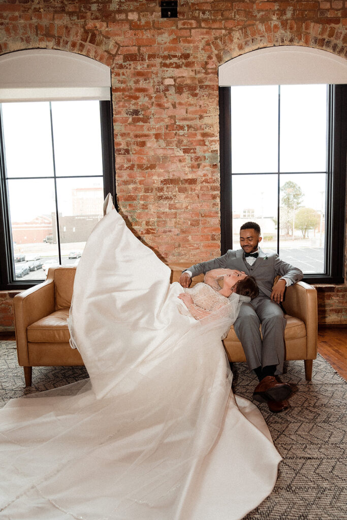 Congdon Yards Pine Room at the Loft bride laying on couch with groom