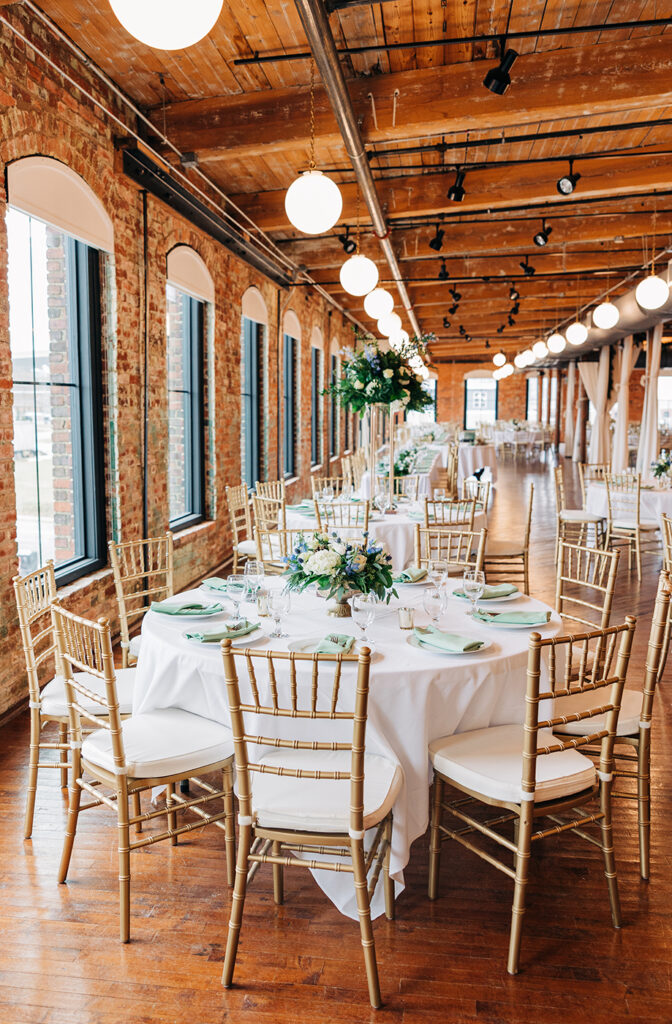 Congdon Yards Pine Room at the Loft brightly lit banquet tables with greenery