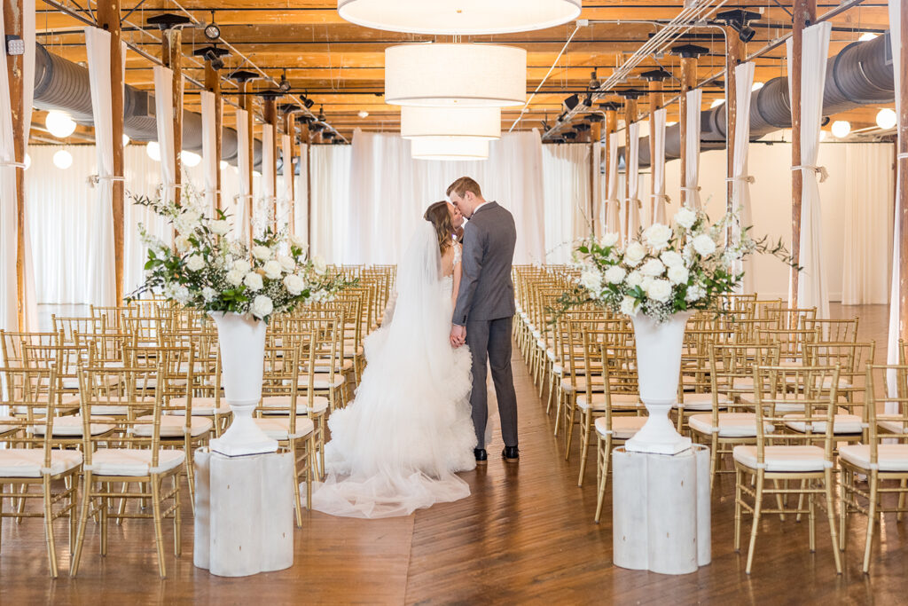 Congdon Yards Pine Room at the Loft couple kissing in aisle