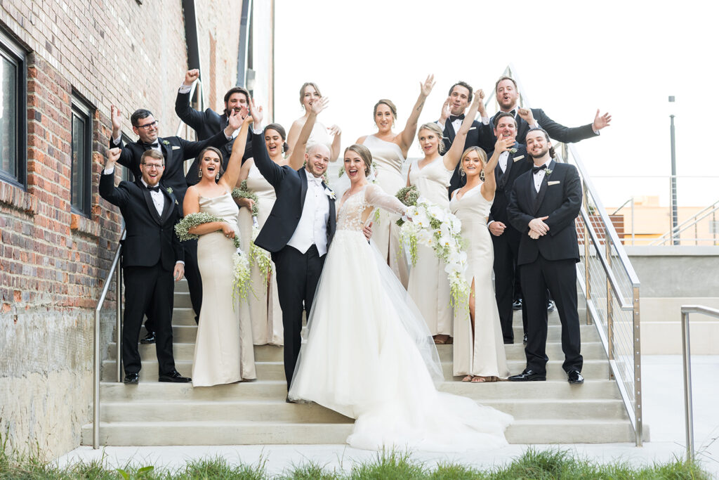 congdon yards courtyard bridal party celebrating on stairs