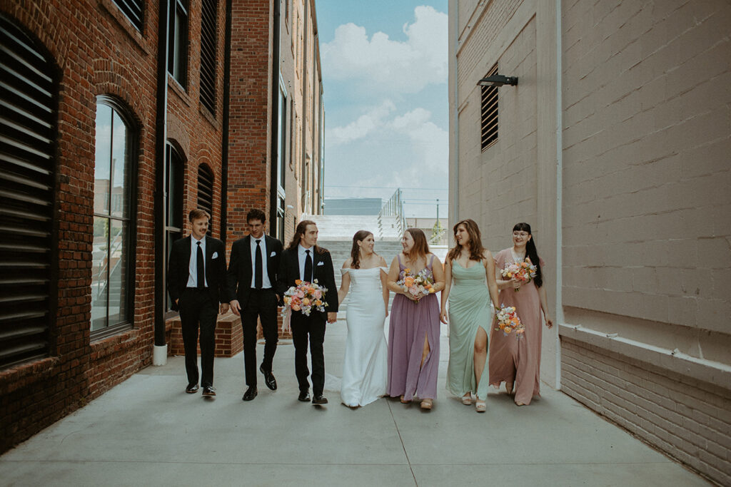 congdon yards courtyard bridal party in alley walking