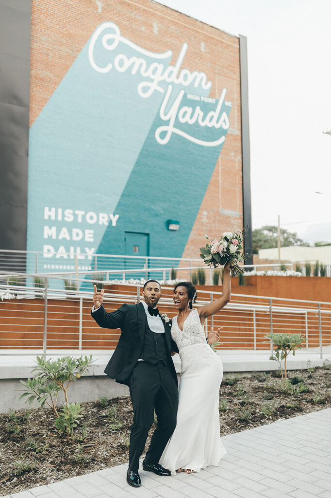 congdon yards courtyard bride and groom celebrating