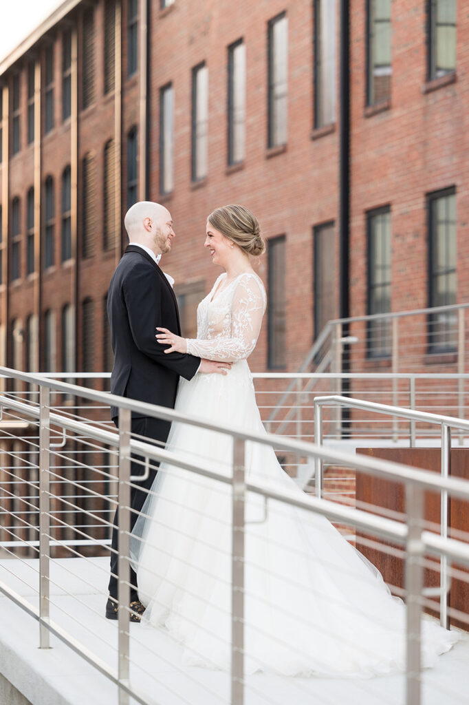 congdon yards courtyard bride and groom embrace brick in background