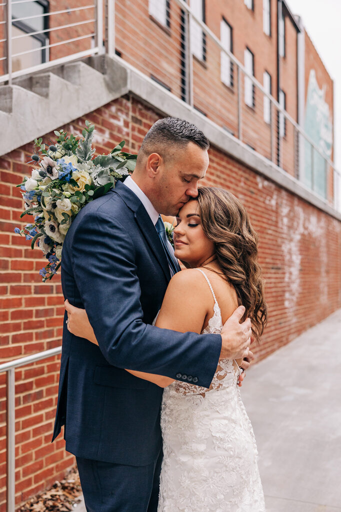 congdon yards courtyard bride and groom embracing