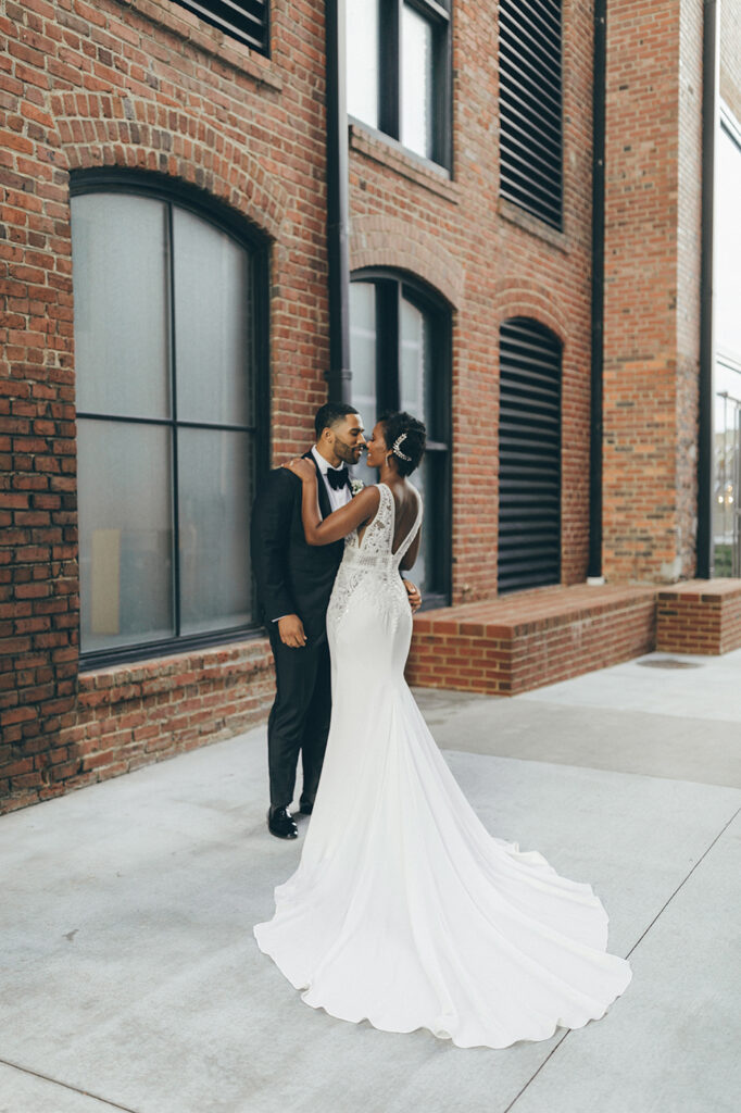 congdon yards courtyard bride and groom kiss in historic venue