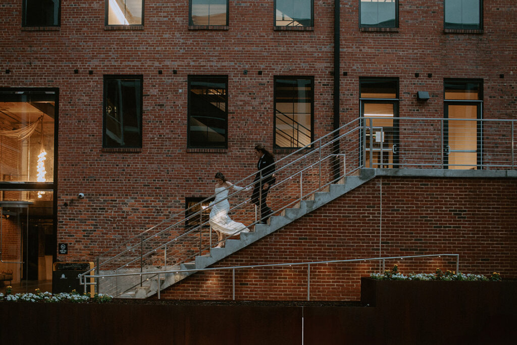 congdon yards courtyard bride and groom walking down stairs at night