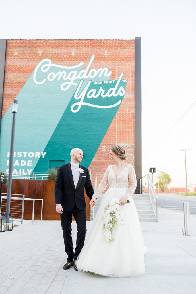 congdon yards courtyard bride and groom with mural