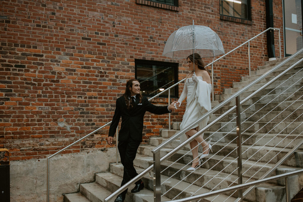 congdon yards courtyard bride and groom with umbrella