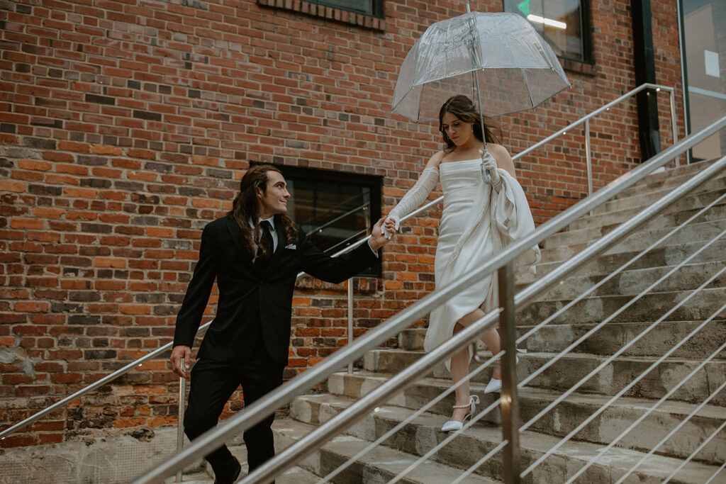 congdon yards courtyard bride and groom with umbrella closeup