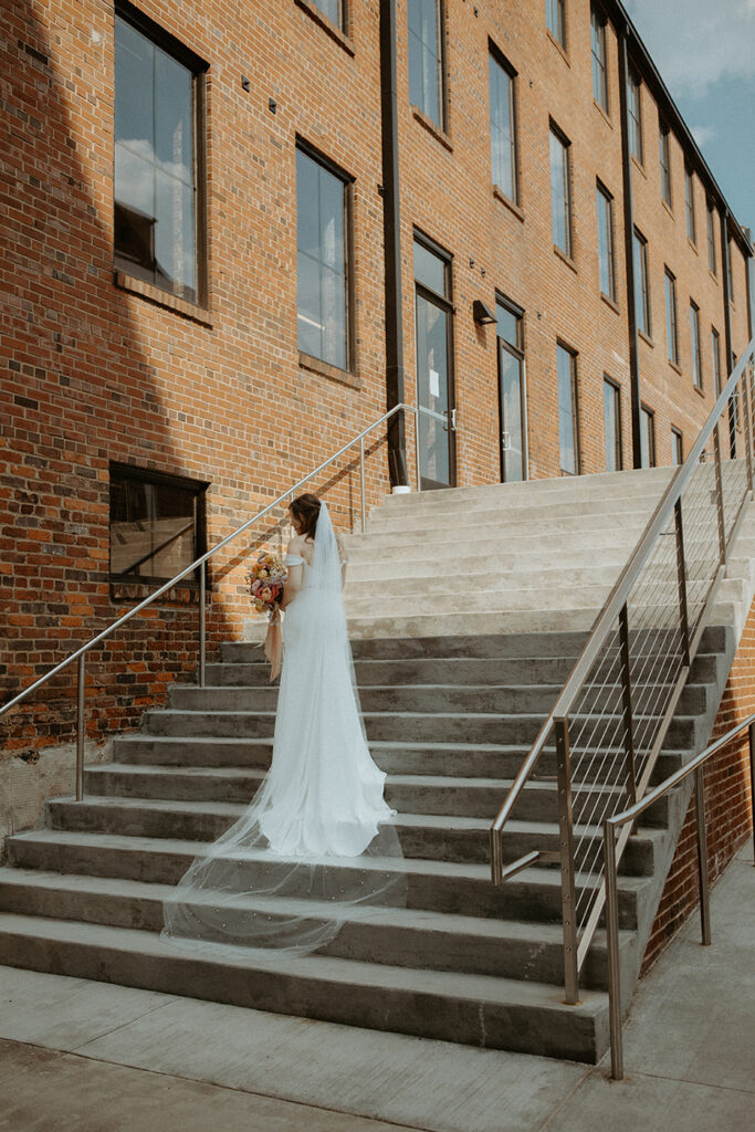 congdon yards courtyard bride on stairs with veil