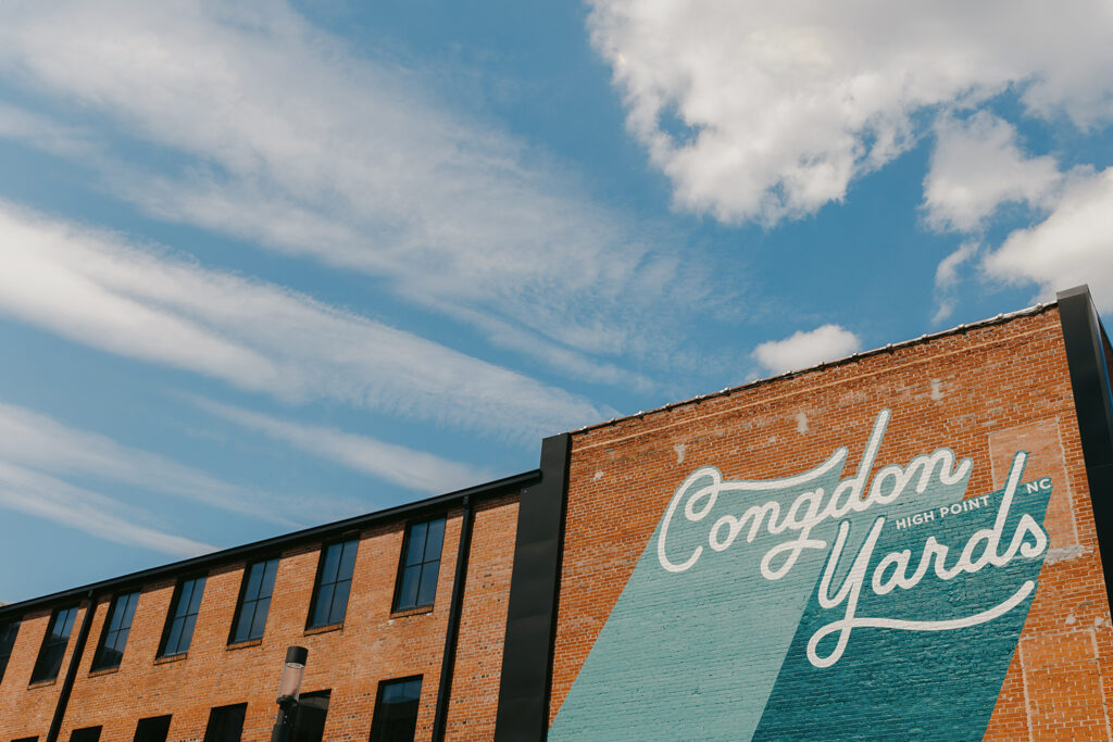 congdon yards courtyard mural with blue sky and clouds