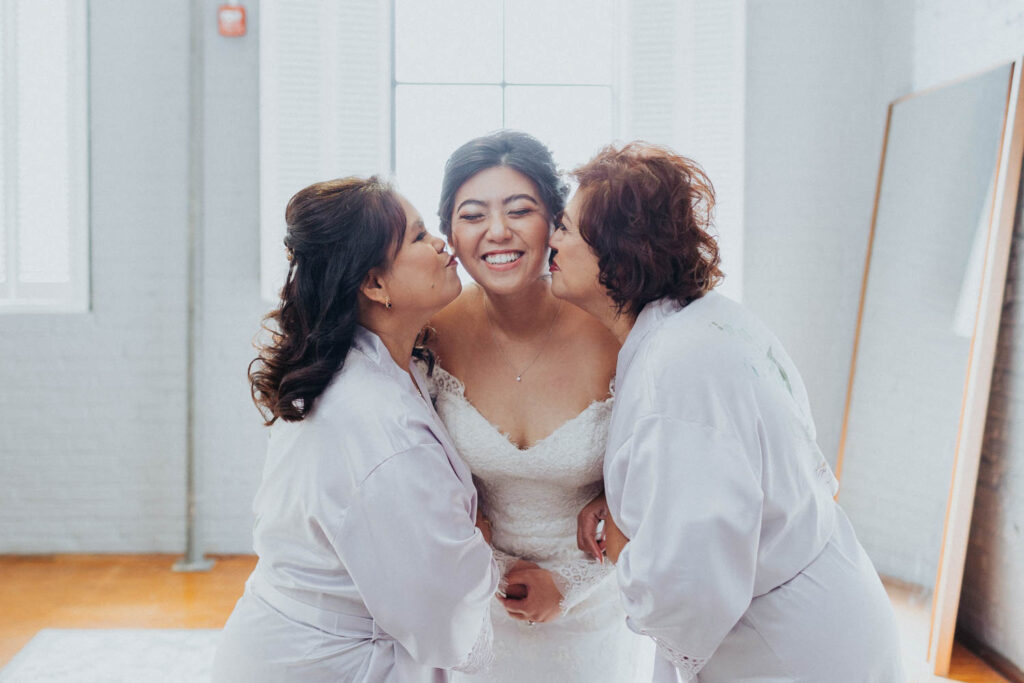 congdon yards luxe suite bride being kissed on cheek by mom