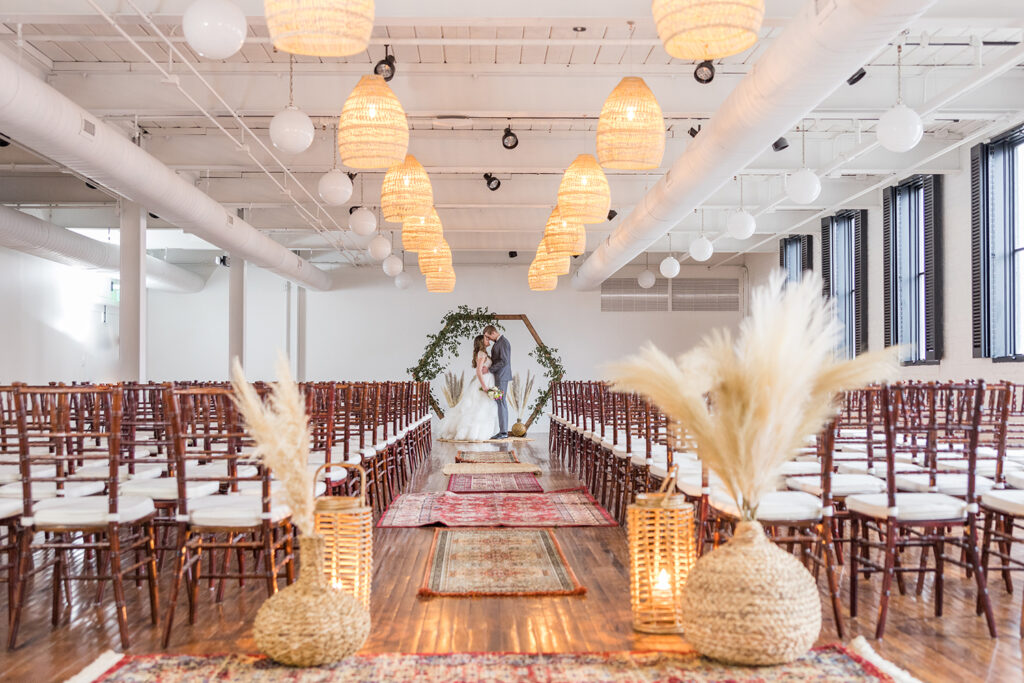 congdon yards silk room at the loft bride and groom at end of aisle