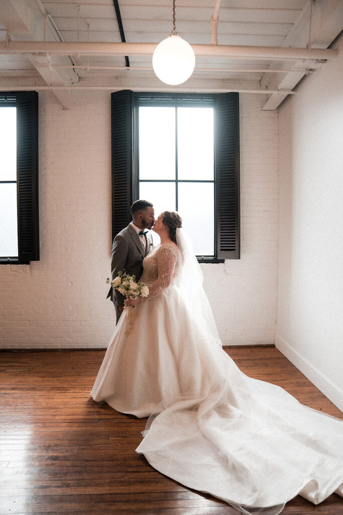 congdon yards silk room at the loft bride and groom kissing