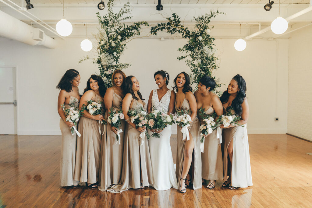 congdon yards silk room at the loft bridesmaids laughing with backdrop