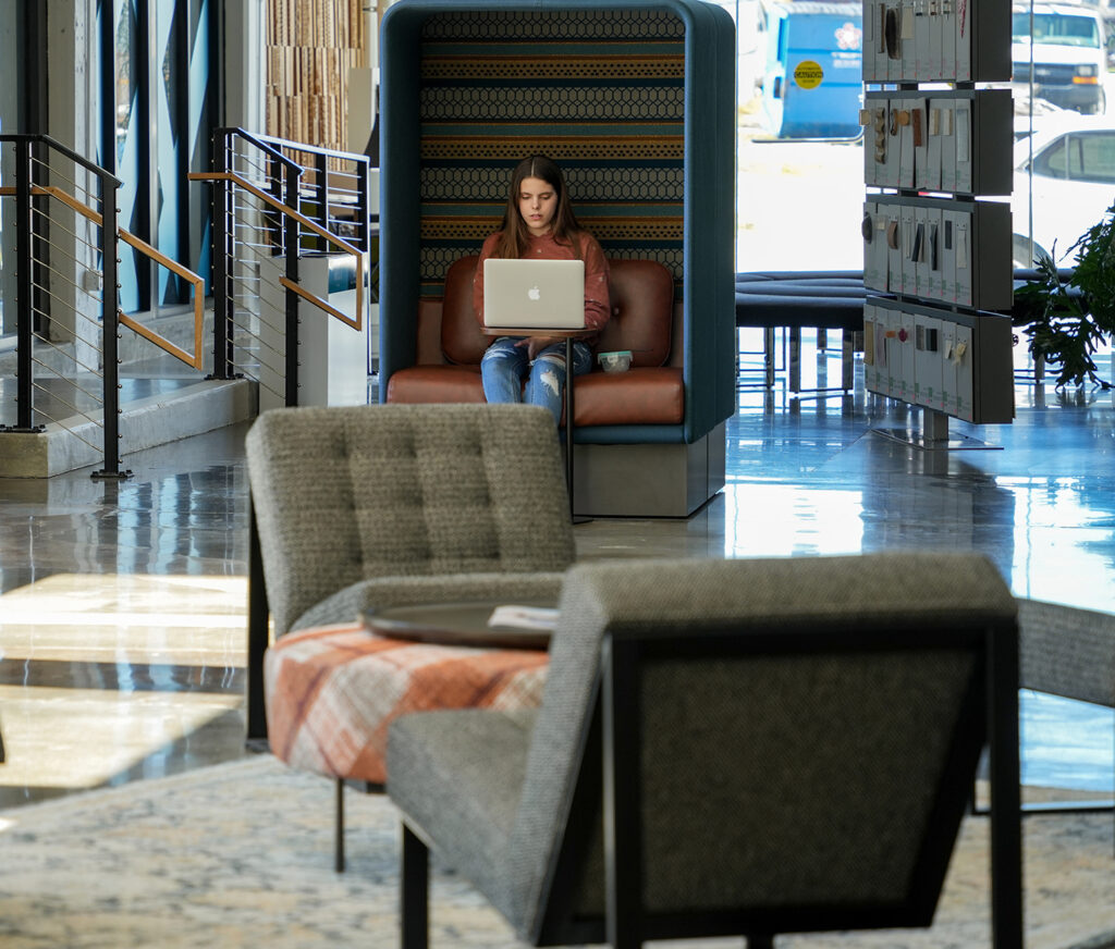 congdon yards the commons woman working in seating cubicle