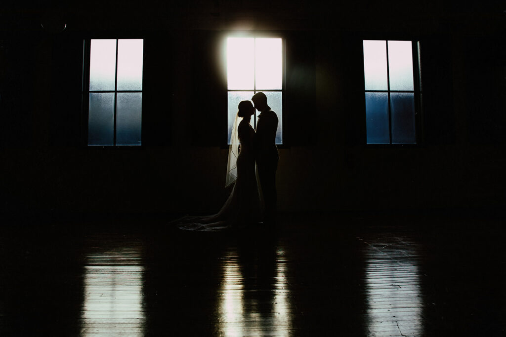 congdon yards the factory bride and groom in front of window