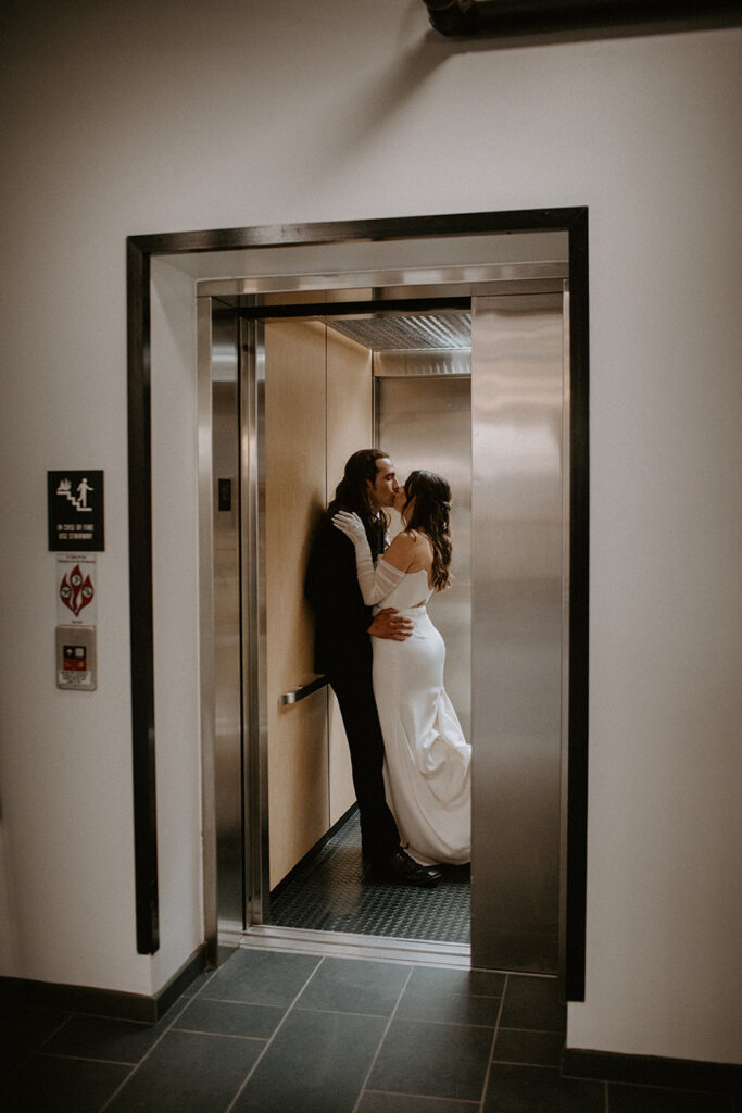 congdon yards the factory bride and groom kissing in elevator