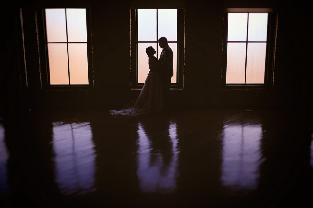 congdon yards the factory bride and groom silhouette in front of window