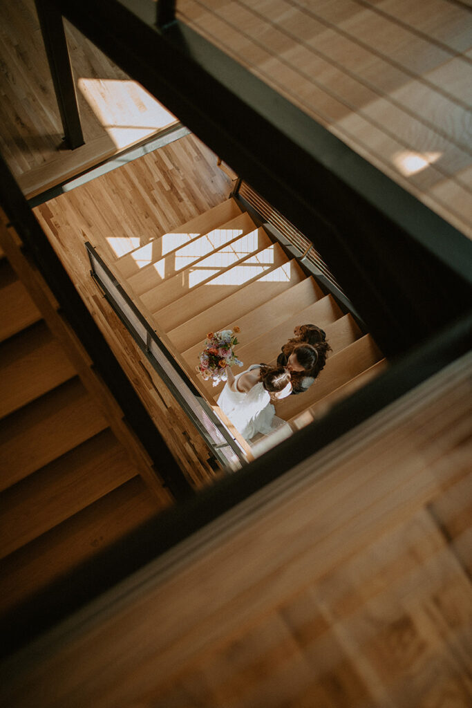 congdon yards the factory bride and groom walking on stairs from above